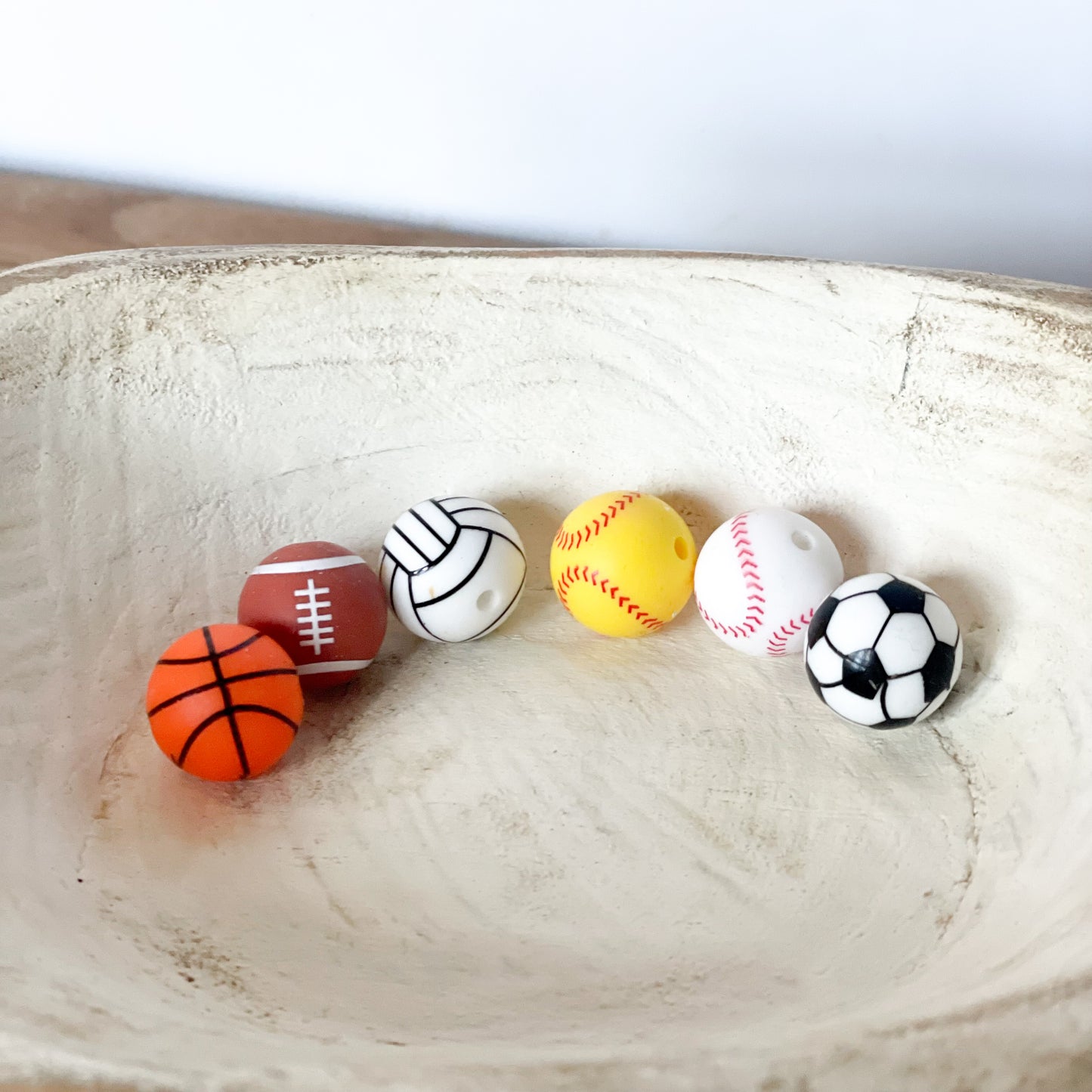 Loose printed silicone beads - left to right basketball, football, volleyball, softball, baseball, soccer